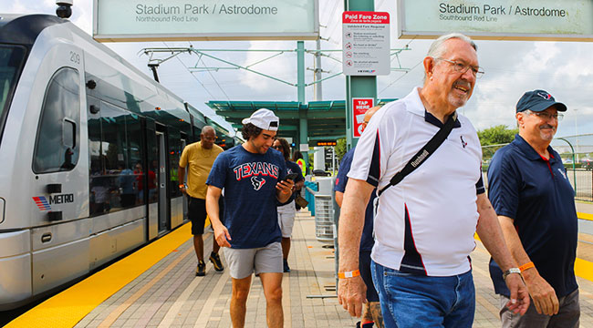 Texans fans getting off the train at Stadium Park / Astrodome and heading to the game.